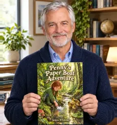Author James Whitaker holding his book Penny’s Paper Boat Adventure